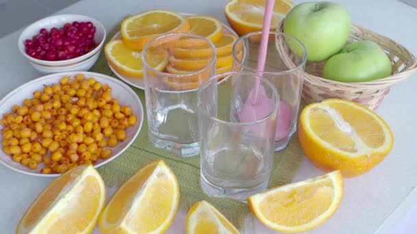 Gyümölcs és bogyó smoothies és narancs szeletek az asztalon. Hasznos diétás reggeli — Stock videók