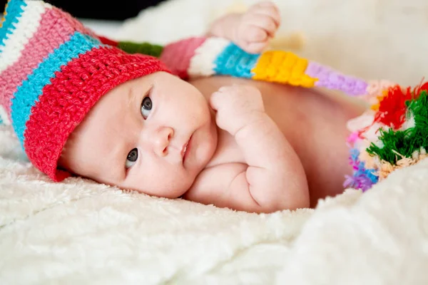 Beautiful two-month-old girl in a red hat. Close-up portrait — Stock Photo, Image