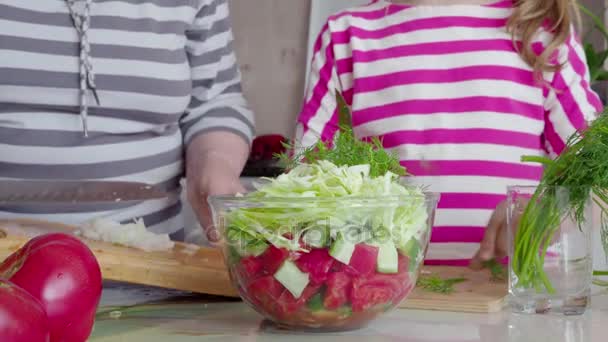 Preparation of salad close-up. Hands of grandmother and granddaughter. 4K — Stock Video