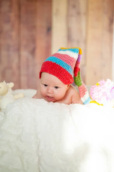 Portrait of a beautiful newborn baby in a red hat — Stock Photo, Image