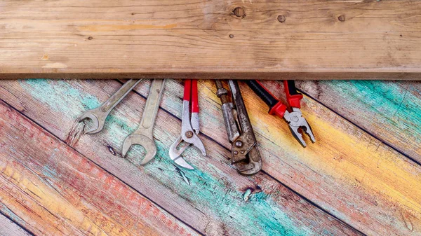 Hand tools for repair and construction on a wooden background