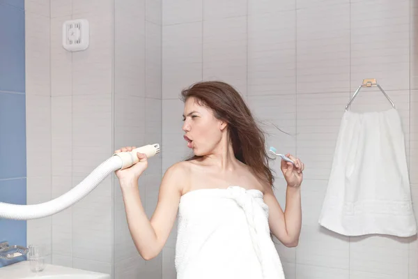 Mujer joven secando el cabello después de la ducha en el baño ligero en casa — Foto de Stock