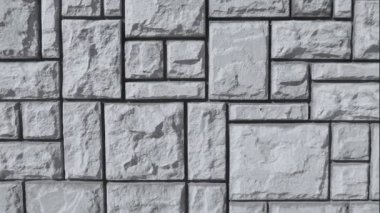 Taş çitin duvarının dokusu dikdörtgen ve kare şeklinde küçük ve büyük boyutlarda.