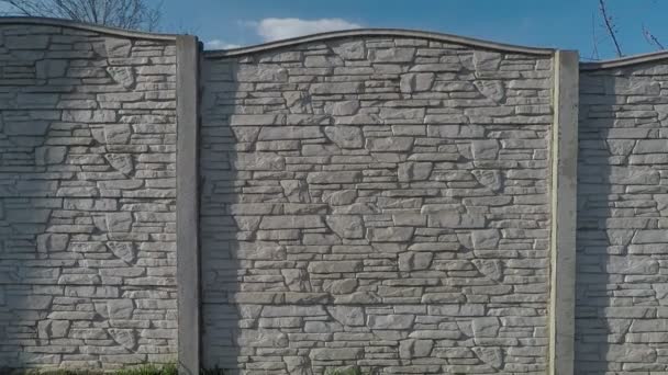 Background texture fence from sections against the sky drawing sandstone — Stock Video