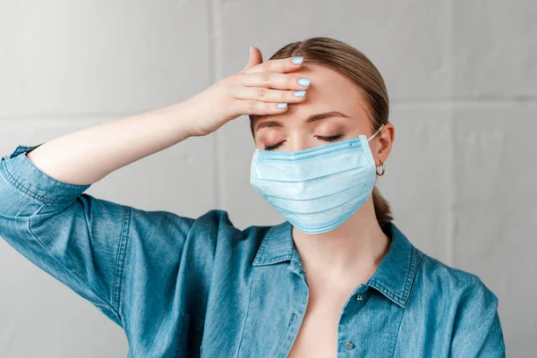 Woman Medical Mask Touching Forehead Closed Eyes — Free Stock Photo