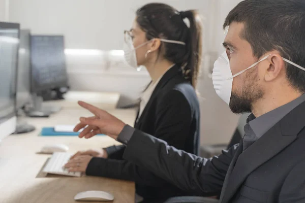 Coronavirus office workers with mask for corona virus. Business workers wear masks to protect and take care of their health. Office working with computer. Working from home.
