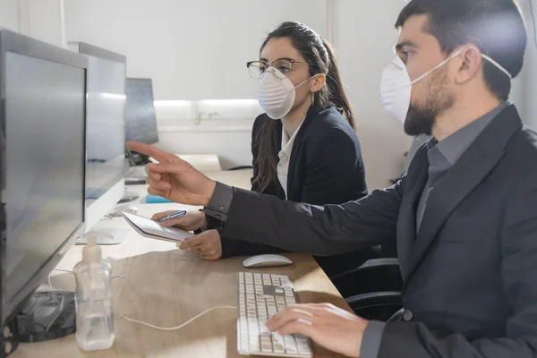 Coronavirus office workers with mask for corona virus. Business workers wear masks to protect and take care of their health. Office working with computer. Working from home.