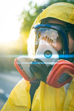 Coronavirus. Maske takıp sokakları temizleyen bir temizlik işçisi. Şehirdeki dezenfekte edilmiş şehirleri sterilize et. Coronavirüs 'e karşı dezenfekte. Kıyafet koruması. 