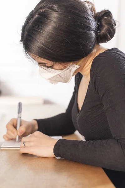 Coronavirus. Woman at the office sick with mask for corona virus. Business women wear masks to protect and take care of their health. Home working with computer. Working from home.