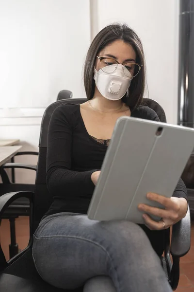 Coronavirus. Woman at the office sick with mask for corona virus. Business women wear masks to protect and take care of their health. Home working with computer. Working from home.