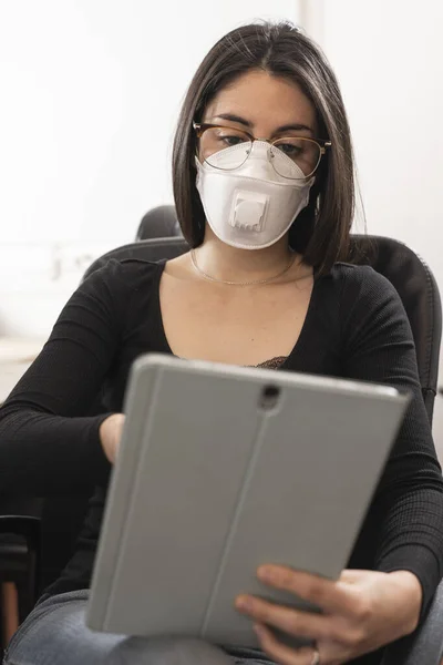 Coronavirus. Woman at the office sick with mask for corona virus. Business women wear masks to protect and take care of their health. Home working with computer. Working from home.