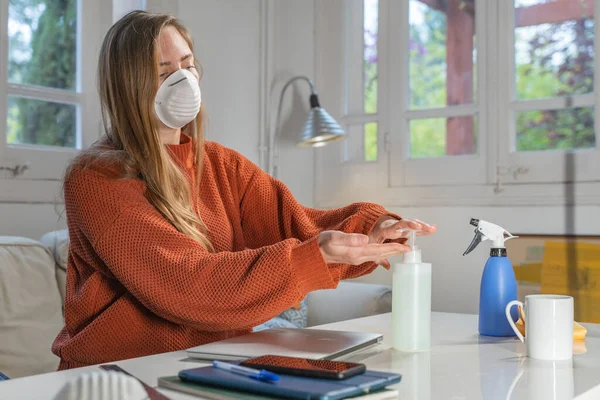 Coronavirus. Woman with face mask and rubber gloves cleaning stuff with a disinfectant at home during the coronavirus epidemic. Infection prevention and control of epidemic. Disinfect your house.