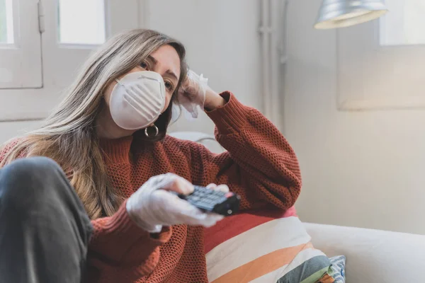 Coronavirus. Woman with face mask and rubber gloves cleaning stuff with a disinfectant at home during the coronavirus epidemic. Infection prevention and control of epidemic. Disinfect your house.