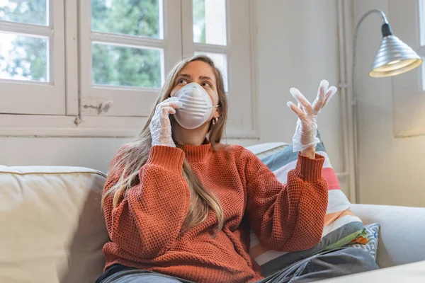 Coronavirus. Woman with face mask and rubber gloves cleaning stuff with a disinfectant at home during the coronavirus epidemic. Infection prevention and control of epidemic. Disinfect your house.