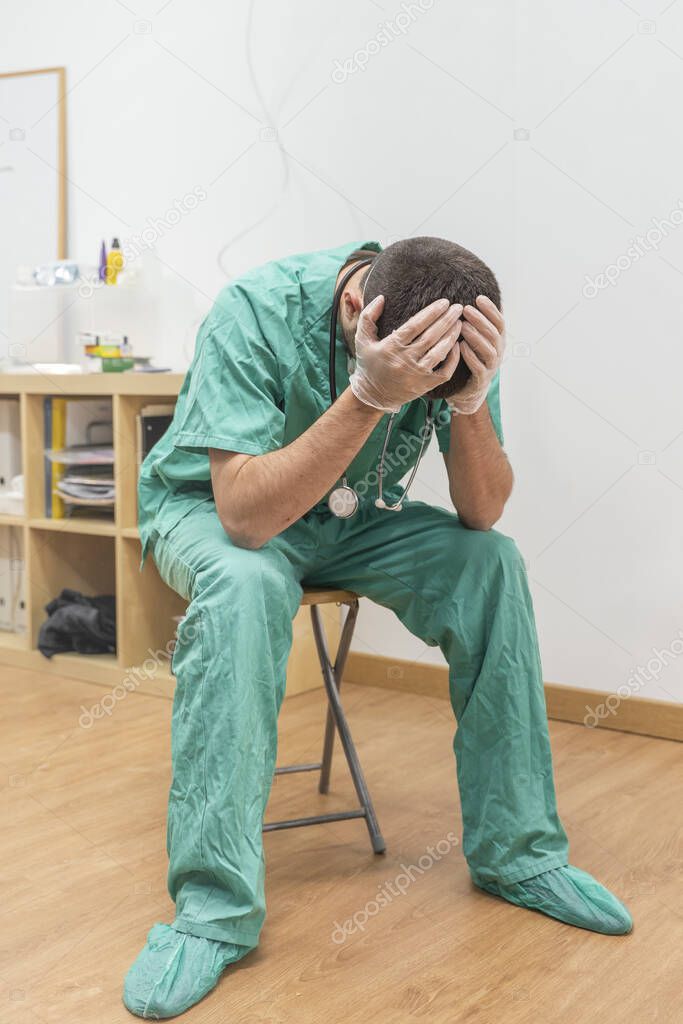 Coronavirus pandemic . Tired exhausted doctor after long shift fighting against Coronavirus (2019-nCoV) at hospital clinic. Global pandemic outbreak SARS-CoV-2 worldwide virus.