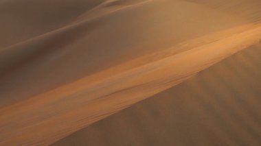 İnanılmaz çöl batımı. Sıcak renkleriyle güzel bir Arap çölü. Abu Dabi 'deki kum tepelerinin renkli hatları. 