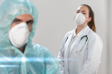 Coronavirus. Hastanede çalışan ve koronavirüsle savaşan doktor ve hemşirelerin portresi. Doktorlar kahramandır. Koruyucu giysili ve maskeli doktorlar hastalığın tedavisini arıyorlar.. 