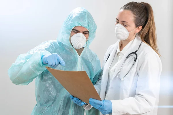 Coronavirus. Portrait of doctors and nurses working in the hospitals and fighting the coronavirus. Doctors are heroes. Doctors in the protective suits and masks looking for a cure for the disease.