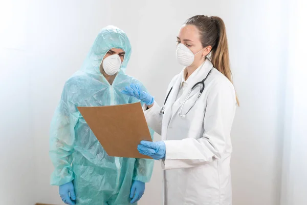 Coronavirus. Portrait of doctors and nurses working in the hospitals and fighting the coronavirus. Doctors are heroes. Doctors in the protective suits and masks looking for a cure for the disease.