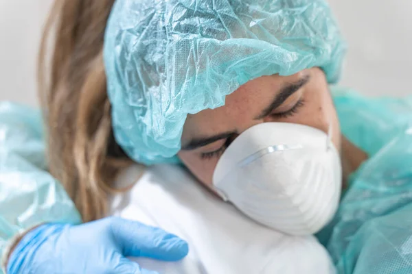 Coronavirus. Portrait of doctors and nurses hugging at hospital and fighting the coronavirus. Doctors are heroes. Wearing protective suits and masks. Great team. Fellowship.