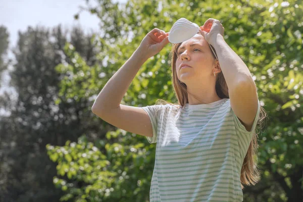 Coronavirus is over we won concept. Woman with mask outdoor in the sunshine freedom. We are safe. Coronavirus ended. We won. No more quarantine. Breathe deep. Take off the mask. Cure.