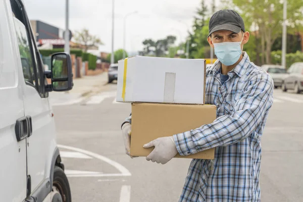 Coronavirus. Deliver man with protective mask and rubber gloves make delivery service. Delivery service under quarantine, disease outbreak, coronavirus pandemic conditions. Transportation. Heroes.