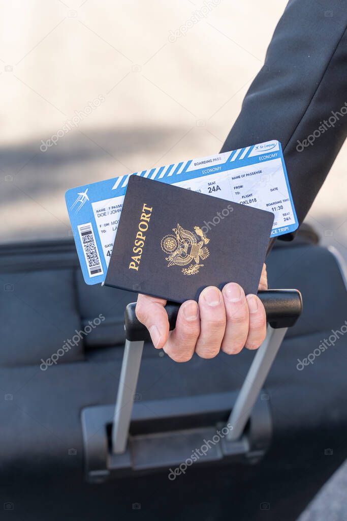 Coronavirus. Air traveler business man wearing face masks walk through the airport with sunlight. Business man wear mask to protect his health. Travel safety. Passport. Boarding pass.