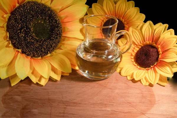 Sunflower Oil Jug Flowers Wood Yellow Glass Black Background — Stock Photo, Image