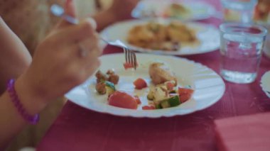 Tabağın içindeki eti çatal ve bıçakla kes.