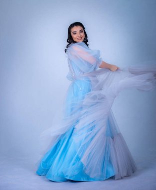 Prenses suretinde genç ve güzel bir manken. Mavi elbiseli bir Sindrella.,