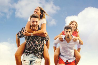 İki çift birlikte sırtına binerek eğleniyor. Yaz yaşam tarzı eğlence aktiviteleri konsepti