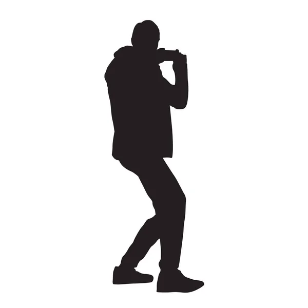 Man taking picture using mobile phone, vector silhouette — Stock Vector