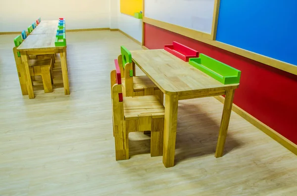 Schreibtische und Stühle im Klassenzimmer des Kindergartens. — Stockfoto