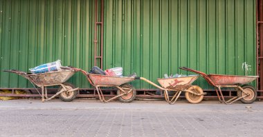 Dört eski çimento arabası ve inşaat atığı..
