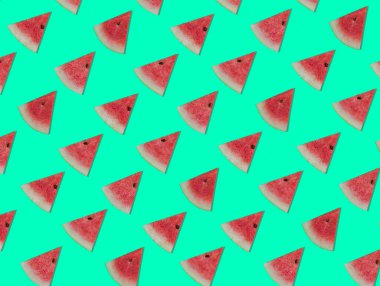 Renkli dilimlerin deseni karpuzu yeşil izole bir zemin üzerinde keser. Karpuzun meyve deseni ve izole edilmiş renk arkaplanı