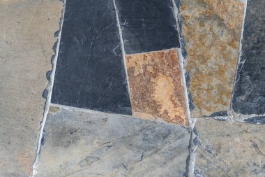 Kahverengi ve koyu gri taş arkaplanının kirli dokusu. Duvar çimento ve siyah levha ile sıvanmış..