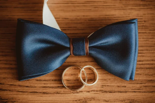 golden wedding rings in box and bow tie