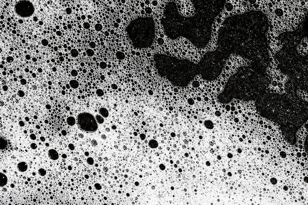 white foam on black water