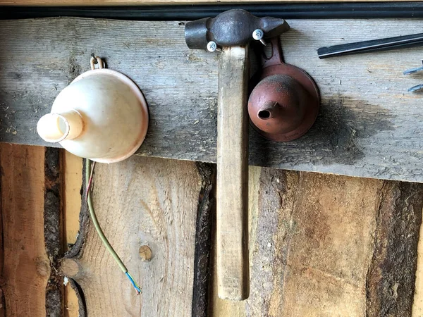 many different old tools hanging on a wooden wall. Father\'s day
