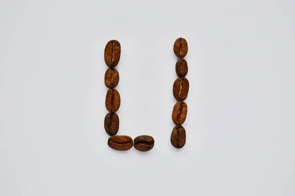 letters l made of coffee beans on the white background.