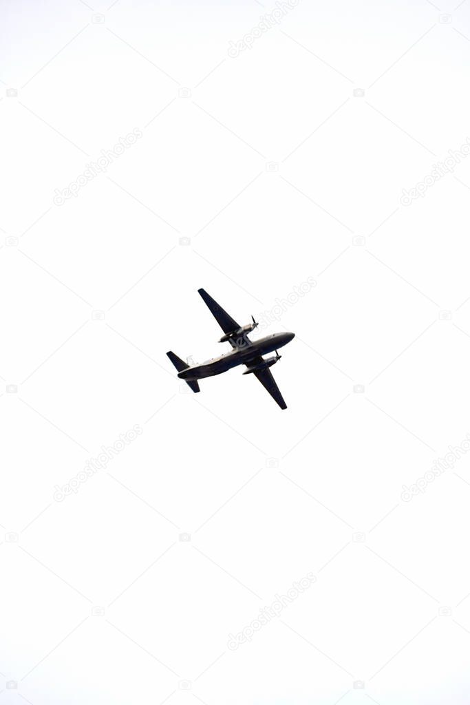 A large plane flies against the sky. Airlines and travel agencies. Vertical background