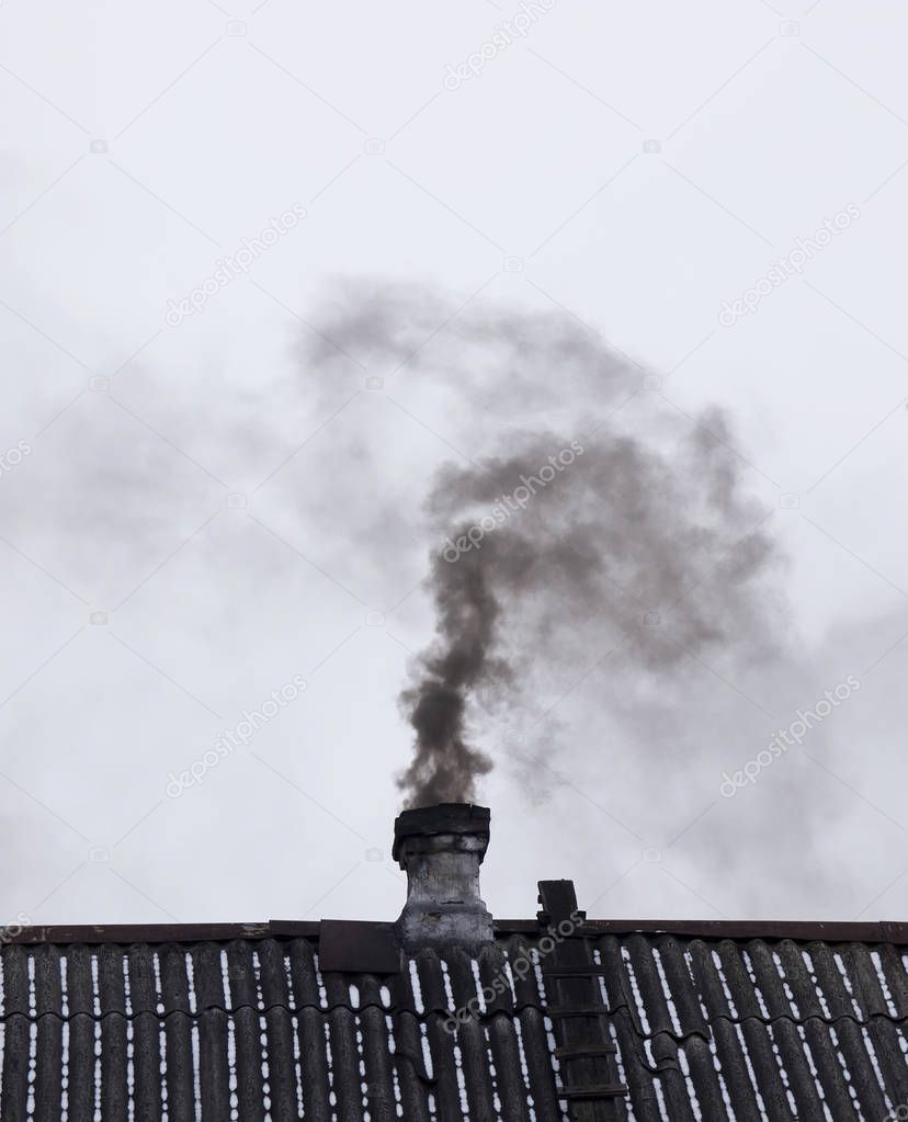 Black smoke comes from the chimney
