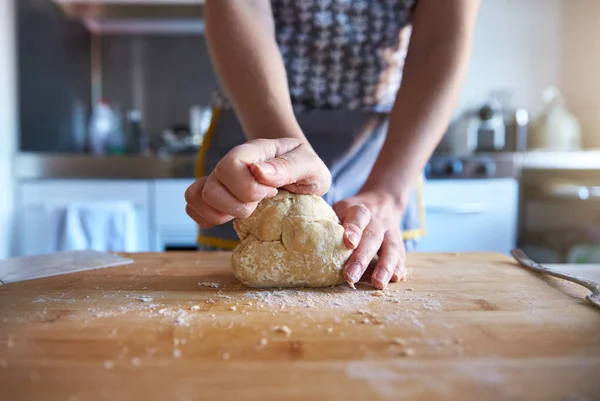 Anonymous Woman making fresh dough at home in her kitchen, close up frame.