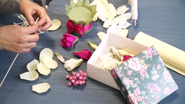 Nahaufnahmen aus Wellpappe hacken grelles Rosa in Frauenhänden. Dekorateurin faltet Origami-Blumen-Knopf aus Papier. Moderne Kunst: Basteln aus Papier für Feste, Hochzeiten und den 8. März — Stockvideo