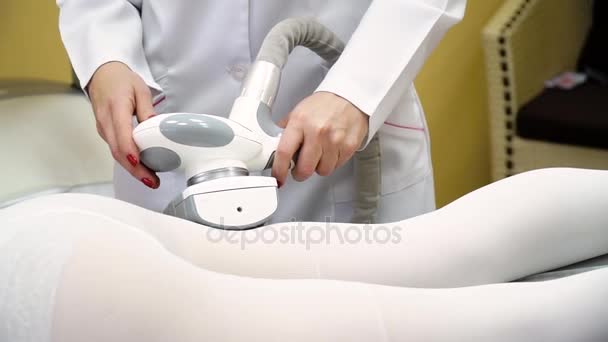 Vrouw is in het proces op de kliniek lipomassage. LPG massage in het schoonheidscentrum. Vrouw liggend op het bed in een spa salon en lipo massage procedure ontvangen. Spa-behandelingen, schoonheidscentrum. — Stockvideo