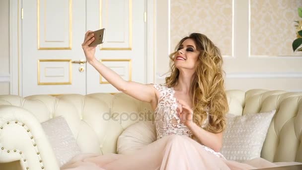 Bella sposa bionda che fa selfie, telefono in mano donna prende una foto, la tecnologia moderna aiuta a comunicare a distanza, una giovane donna che fa foto selfie ai social network e instagramma — Video Stock