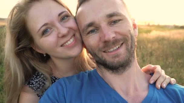 Slow Motion Closeup Of Beautiful Couple Looking At Camera, Backlit By Sunset, In Nature — Stock Video