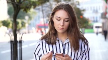 Telefondan kulaklıklar müzik dinlemek sokakta tutan güzel kadın danslar. Ağır çekim