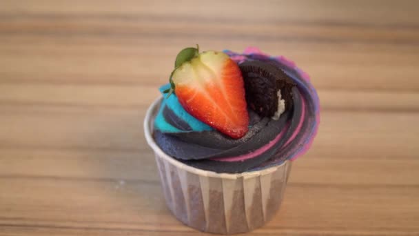 Strooi poeder suiker op lekkere cake, taart decoratie met aardbeien, een stuk van biscuit, veelkleurige glazuur — Stockvideo