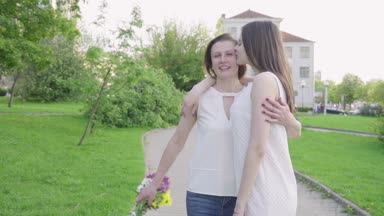 Mutlu kadın ve genç kızı park yürüme. Yetişkin anne ve kızı parkta yürüyüş